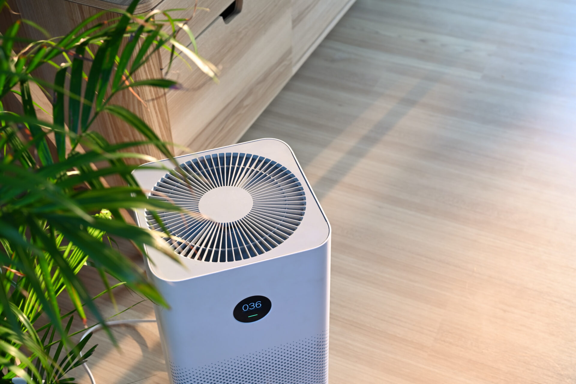 Modern HEPA air purifier in home living room setting